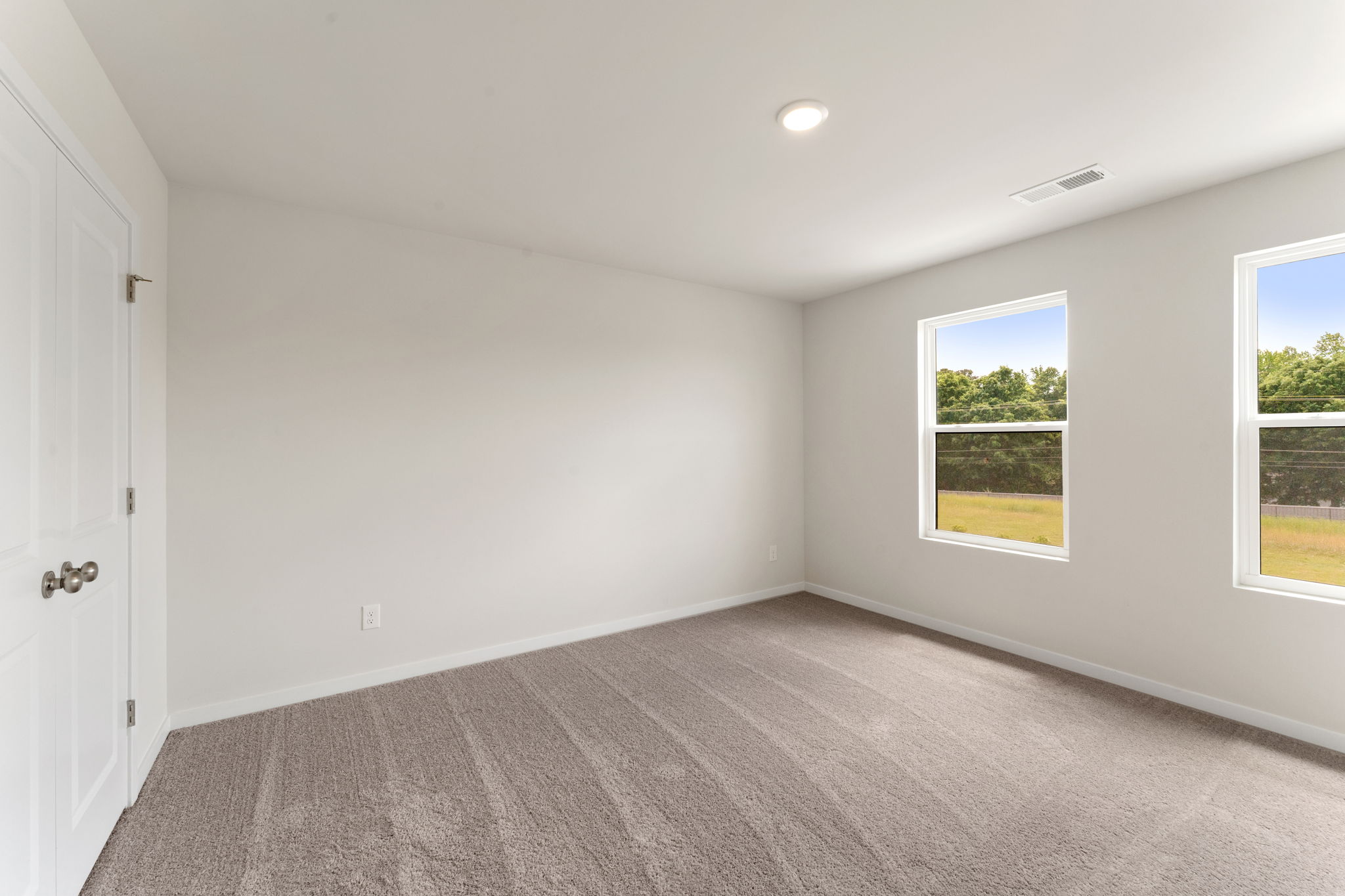 A room with a window and a door.