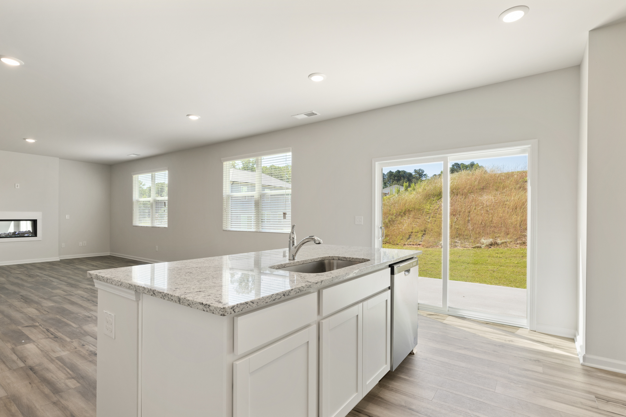 A kitchen with a large window.