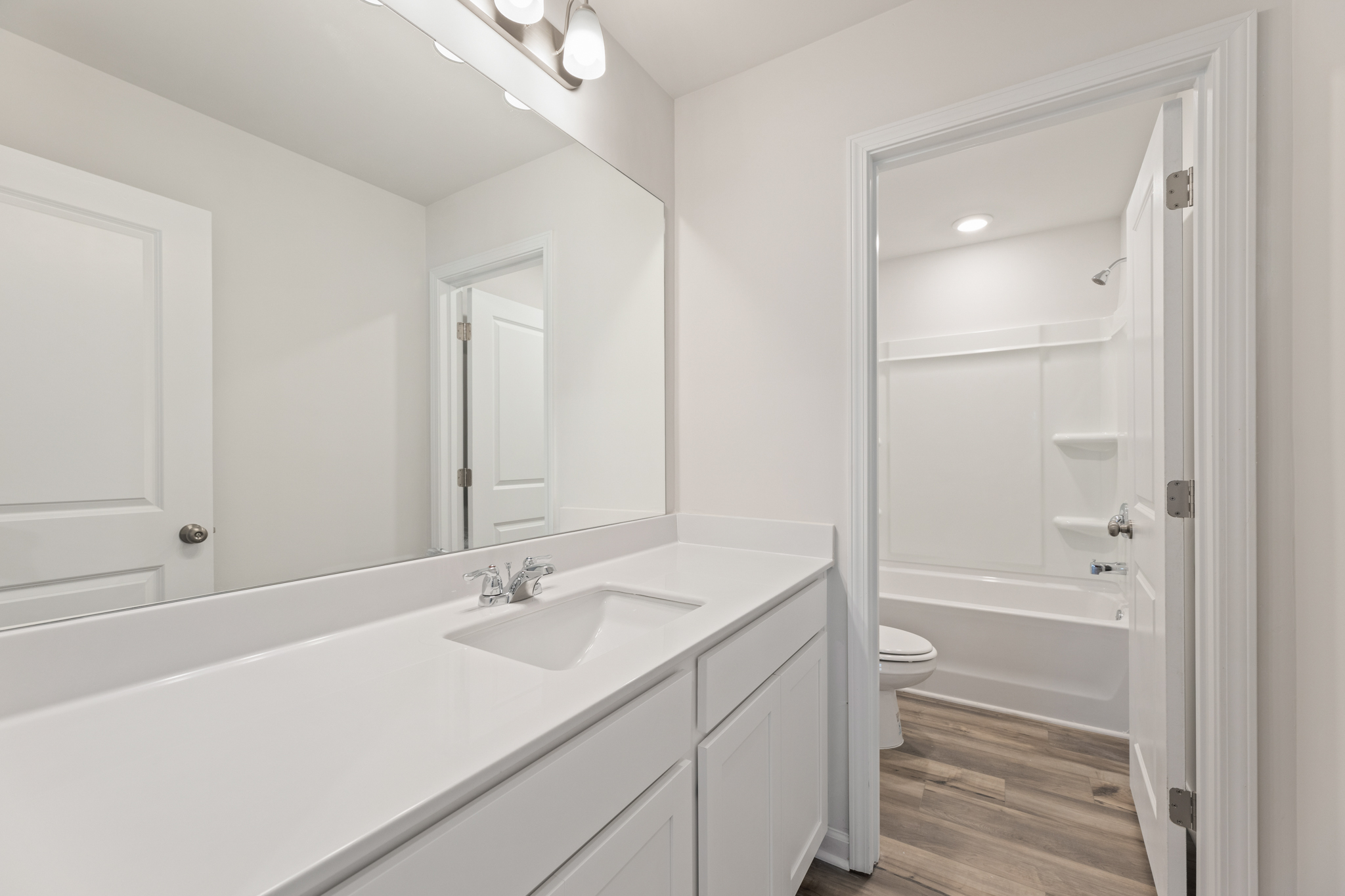 A bathroom with a tub sink and toilet.