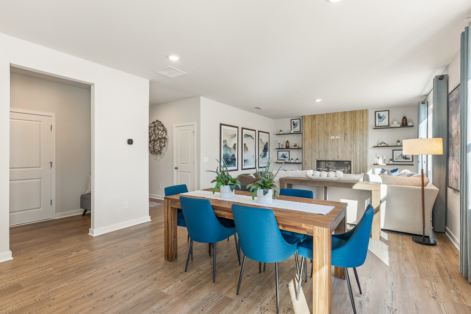 A dining room with a table and chairs.