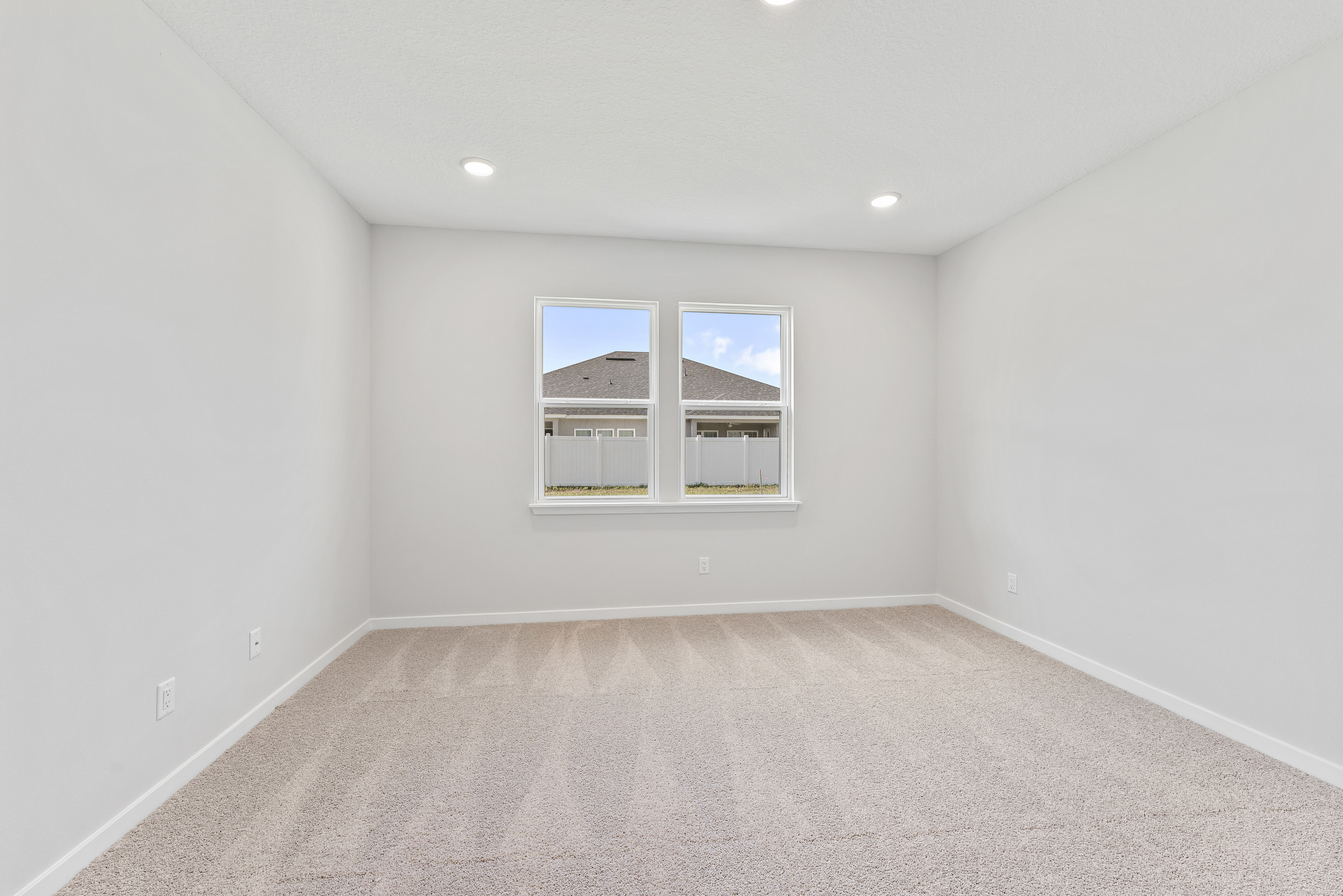 Primary Bedroom with Large Windows in Lot 19 Cedar II at Camden Woods in Kingsland, GA