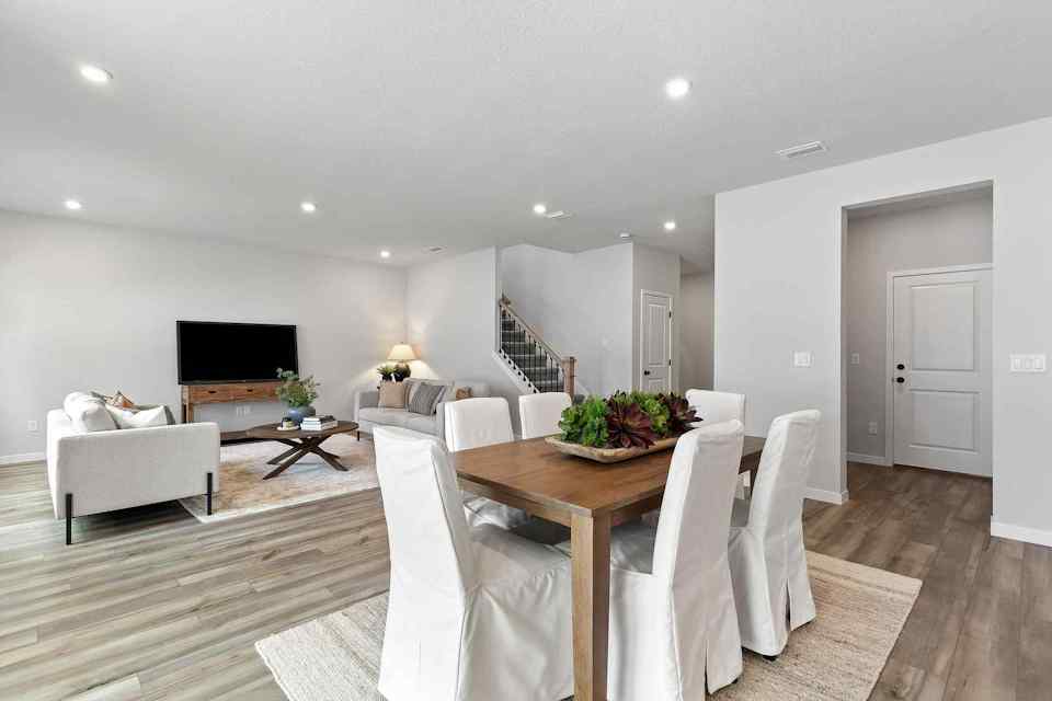A living room with a table and chairs.