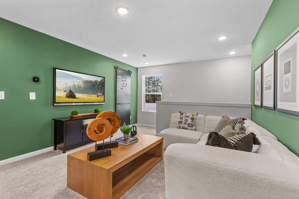 A living room with a couch and a tv.