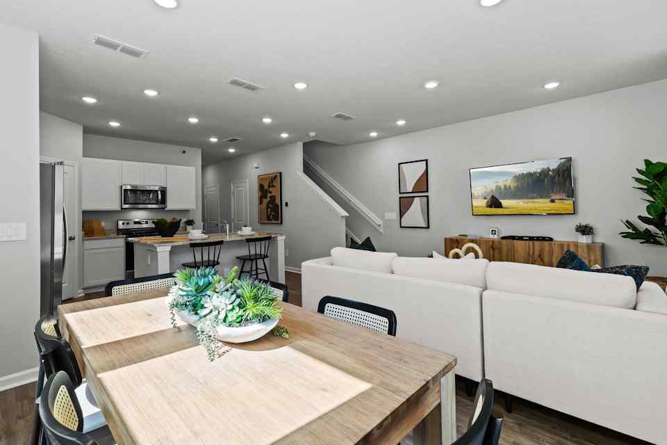 Davor Model Paired Home Wood Dining Table with Black Chairs Overlooking Kitchen The Landings at Pecan Park