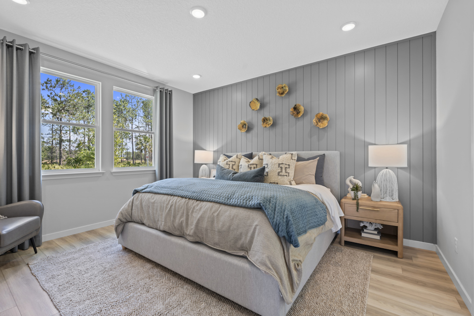 Coronado Model Home Primary Bedroom with Large Bed at Reserve East in Flagler Beach