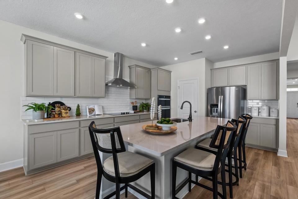 A kitchen with white cabinets.