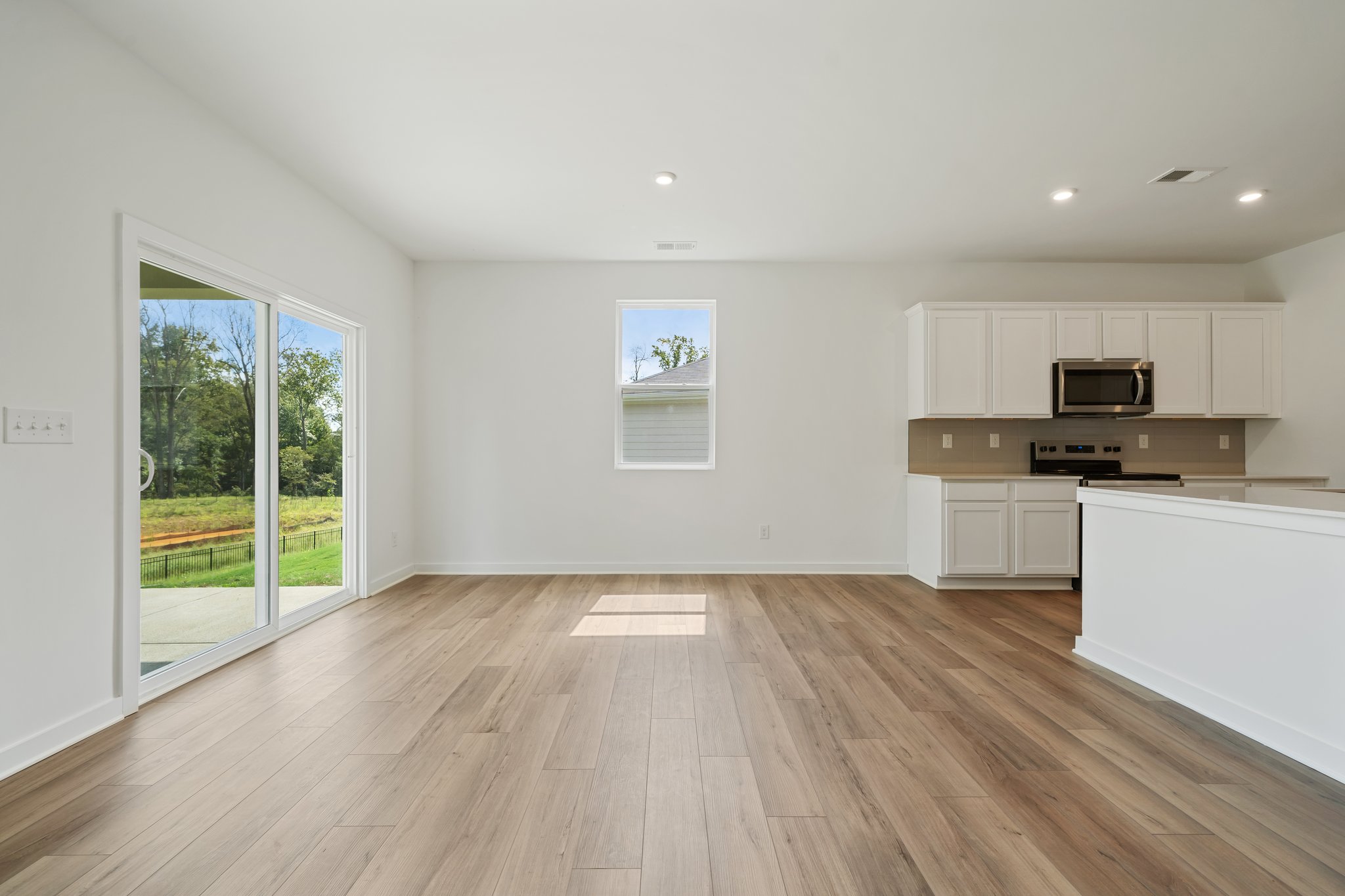 A kitchen with white cabinets.