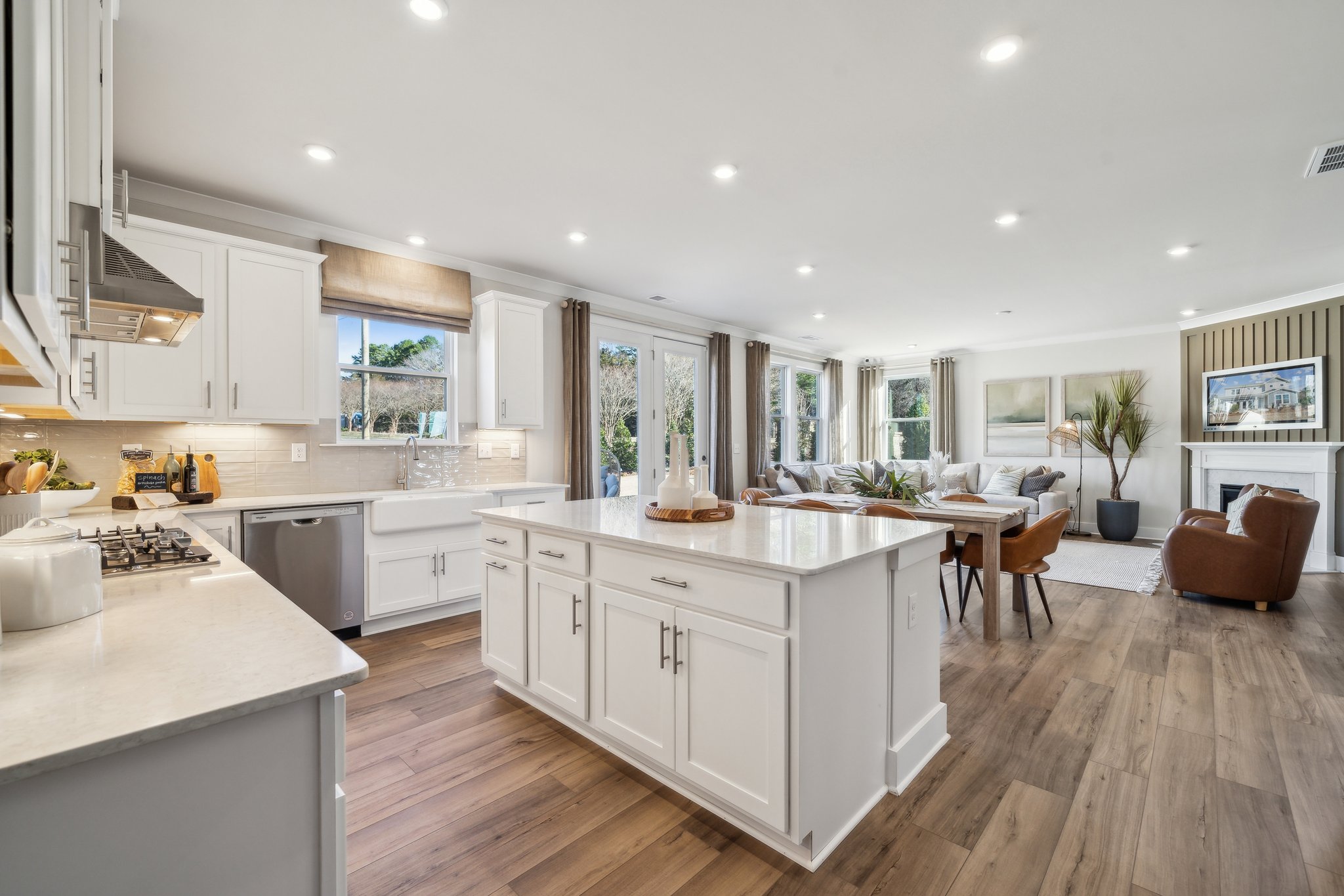 A kitchen with white cabinets.