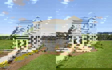 A white house with a lawn.