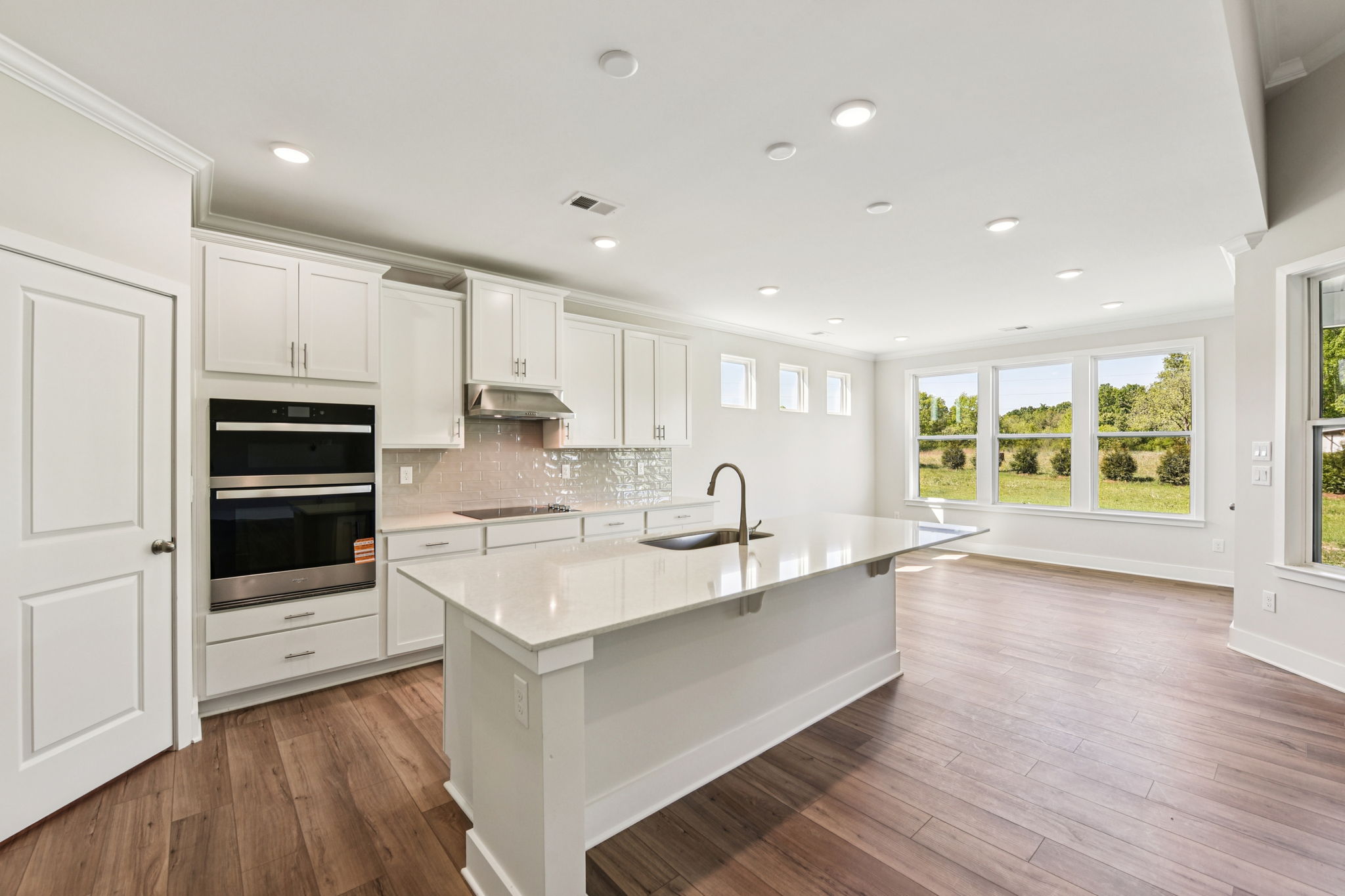 A kitchen with white cabinets.
