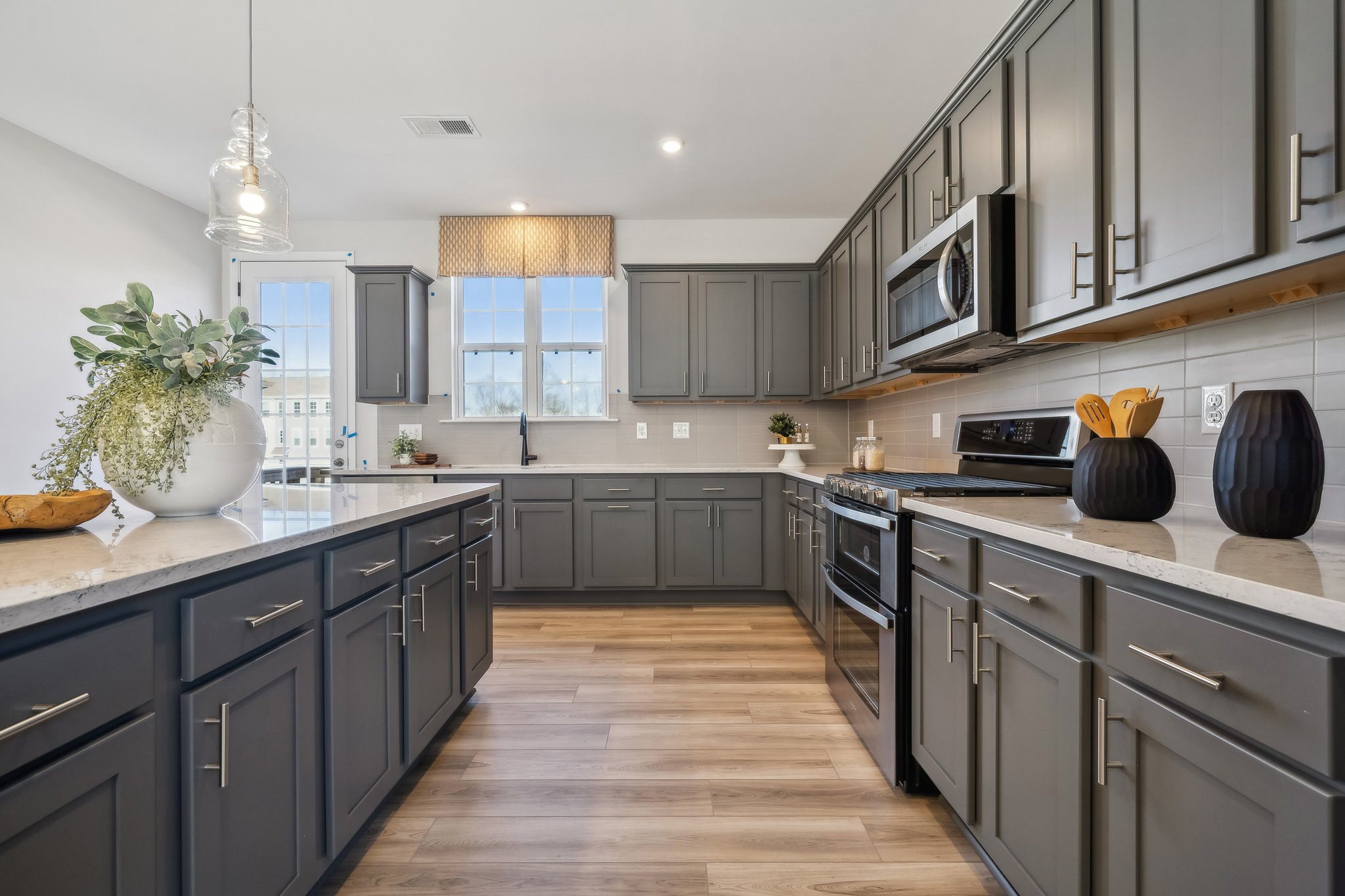 A kitchen with black cabinets.
