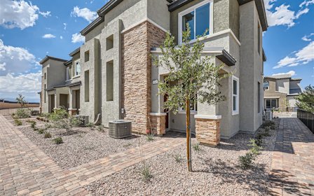 A brick building with a tree in front of it.