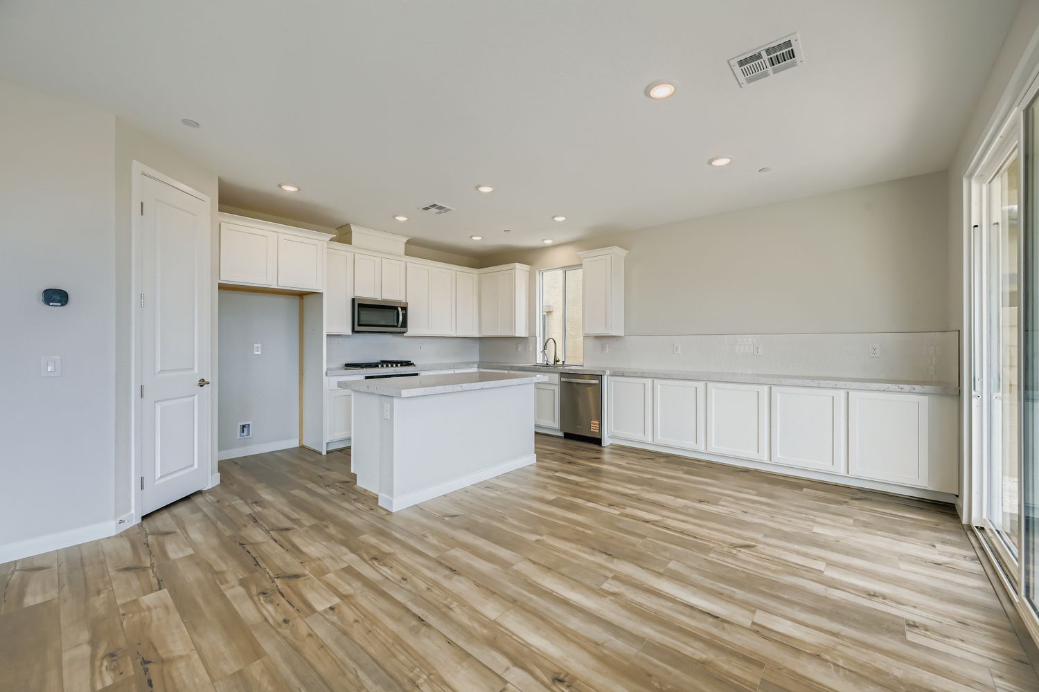 A kitchen with white cabinets.