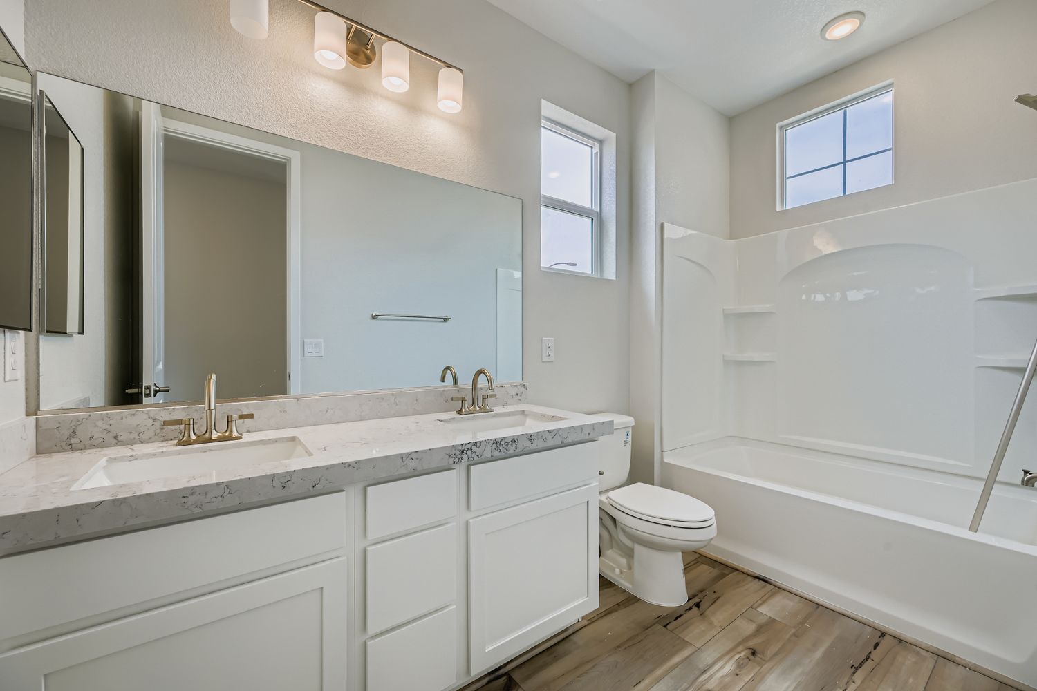 A bathroom with a tub sink and toilet.