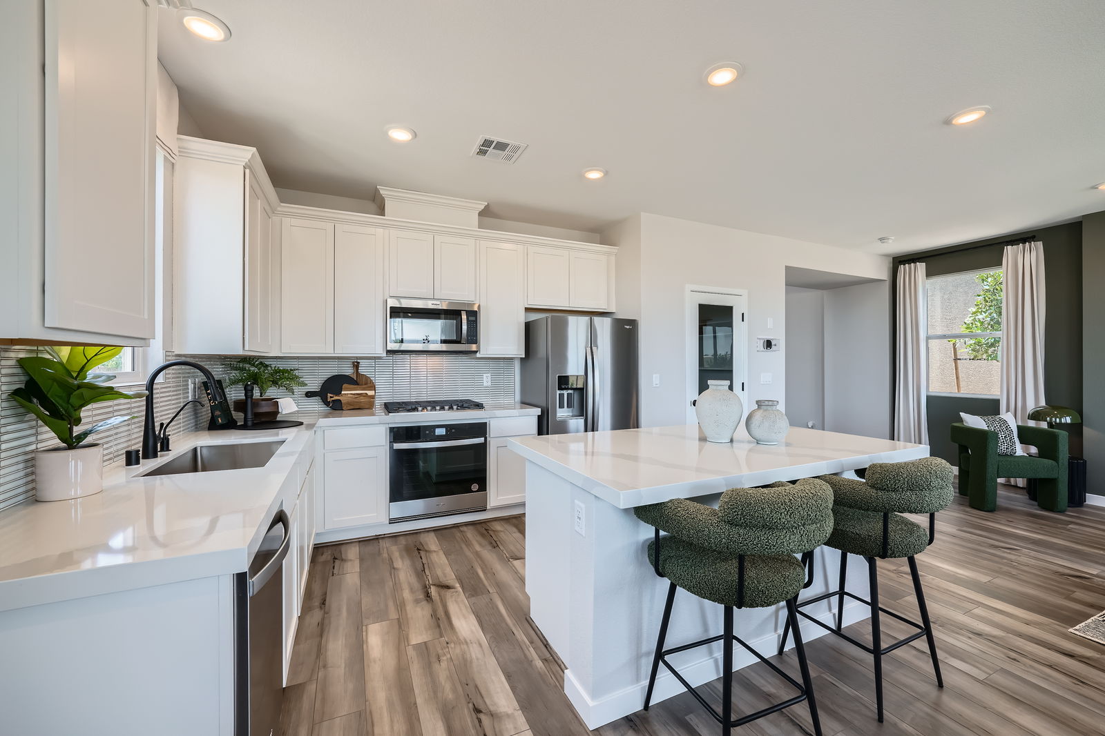 A kitchen with white cabinets.