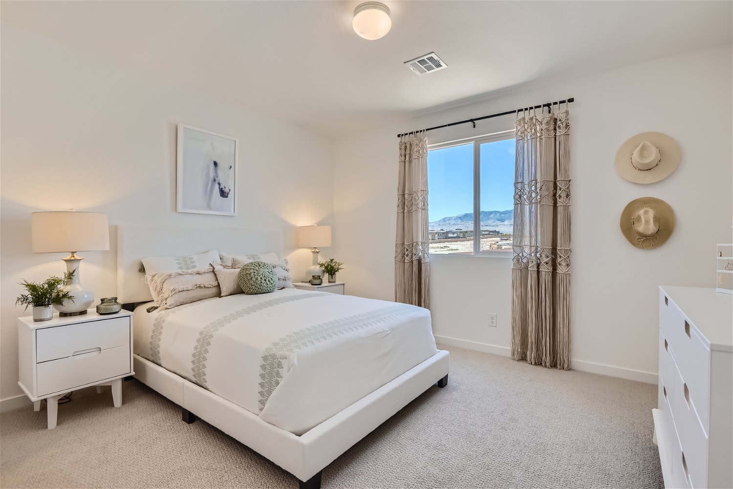A bedroom with a large window.