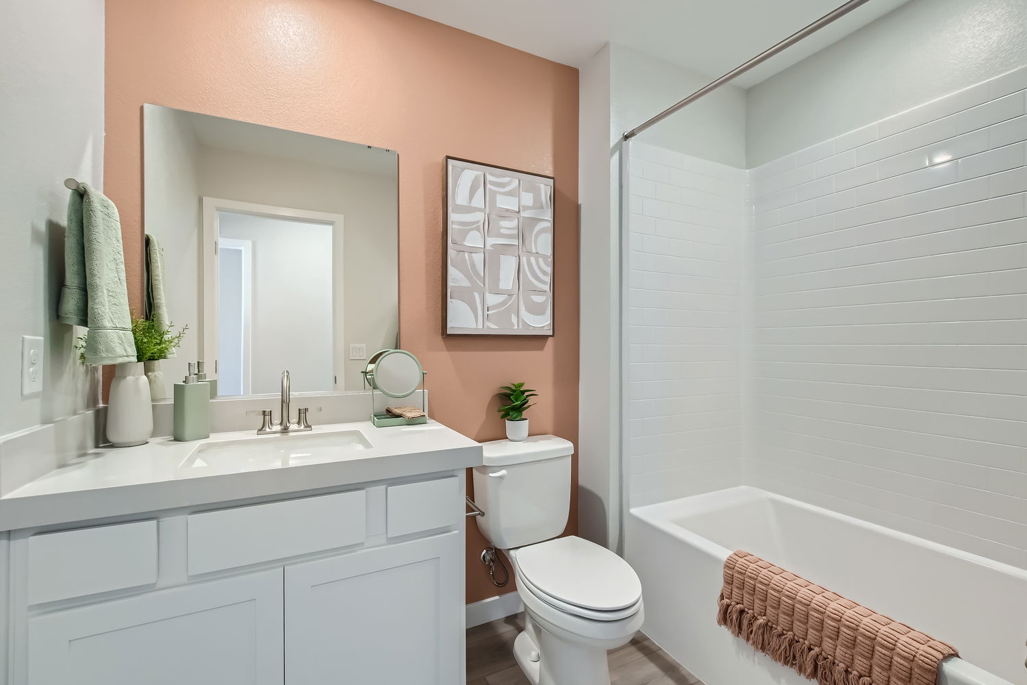 A bathroom with a tub toilet and sink.