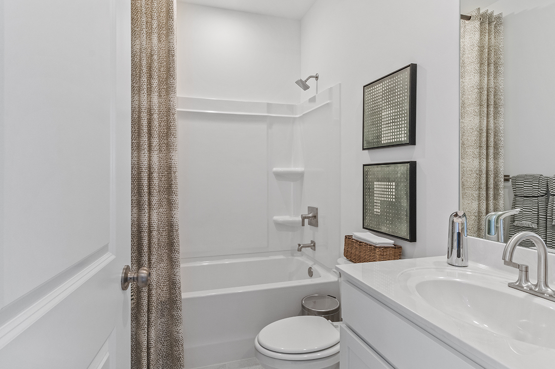 A bathroom with a tub sink and toilet.