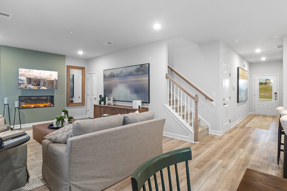 A living room with a staircase.