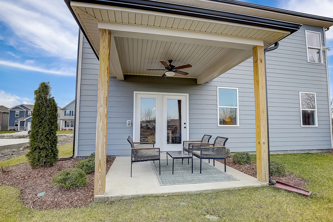 A house with a patio and a table and chairs.