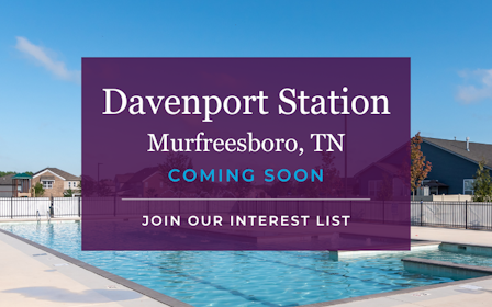 A large purple building with a pool in front of it.