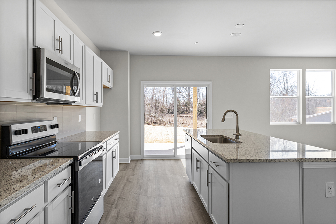 A kitchen with a large window.