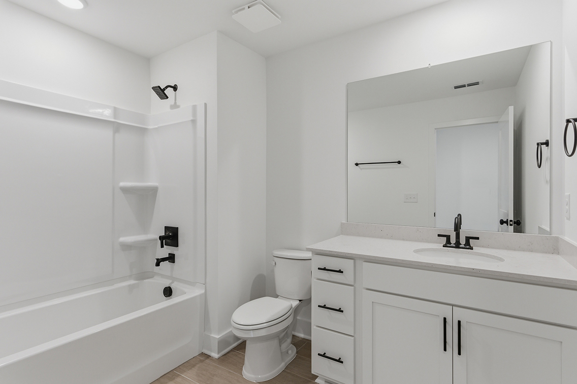 A bathroom with a tub toilet and sink.