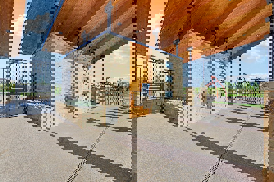 A building with a fence and a brick patio.