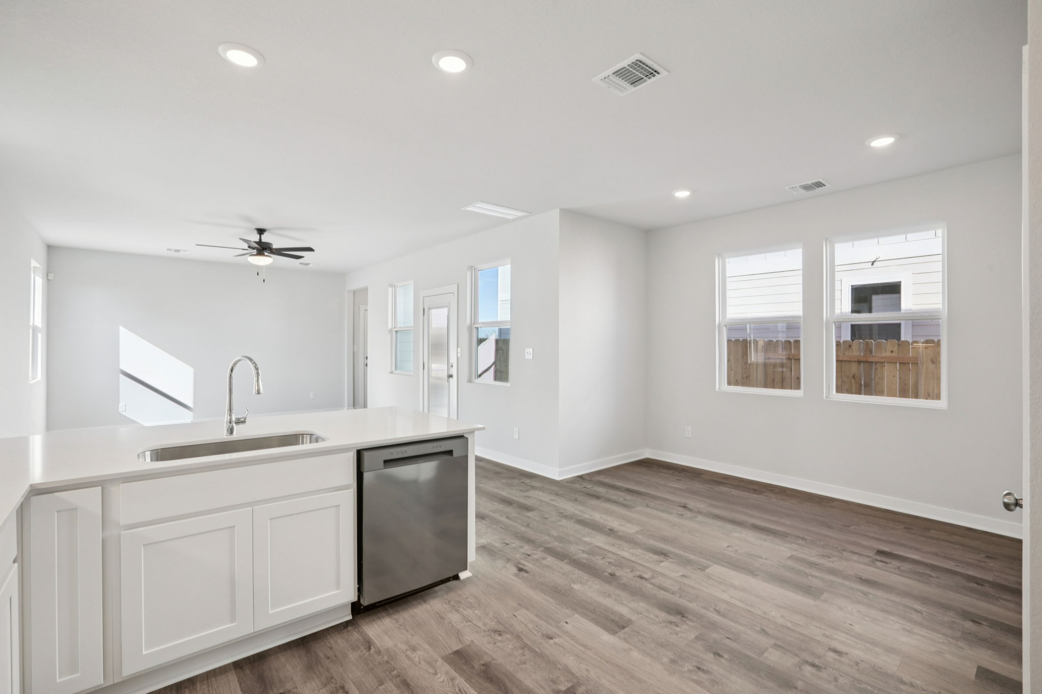 A kitchen with white cabinets.