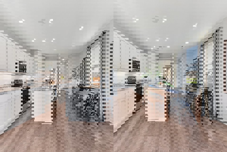 A kitchen with white cabinets.