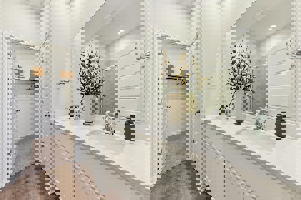 A bathroom with a large mirror.