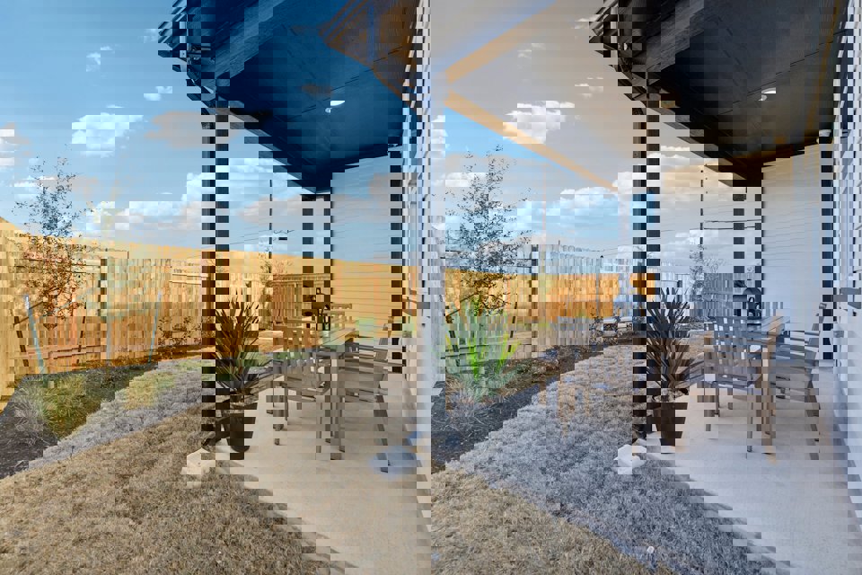 A patio with a table and chairs.