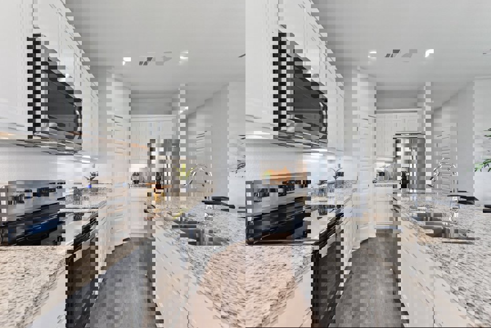 A kitchen with white cabinets.