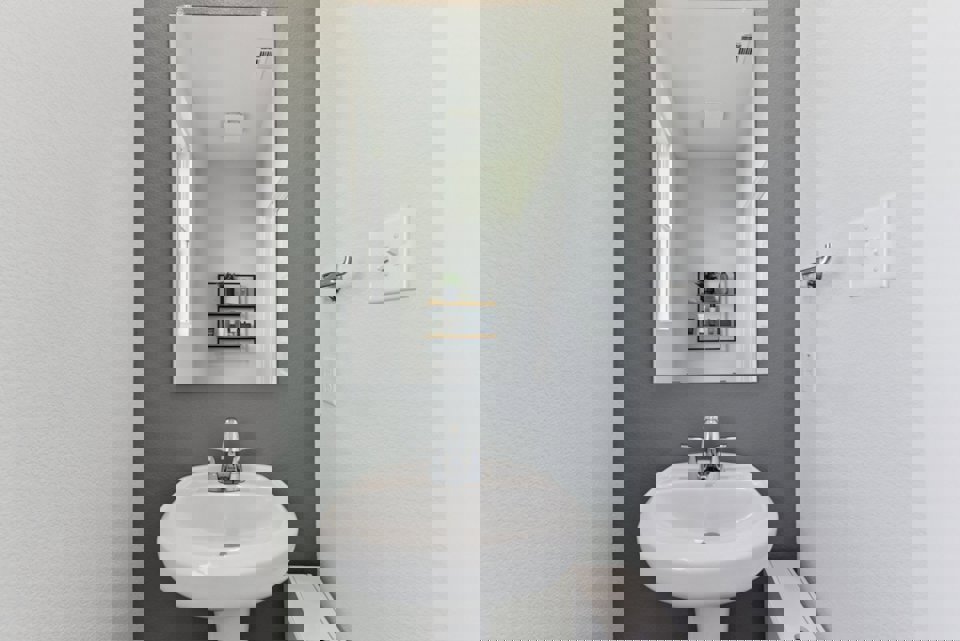 A bathroom with a mirror and sink.