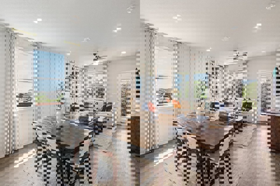 A large living room with a dining table and chairs.