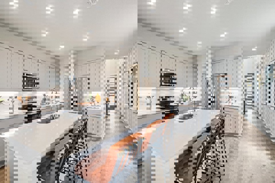 A kitchen with white cabinets.