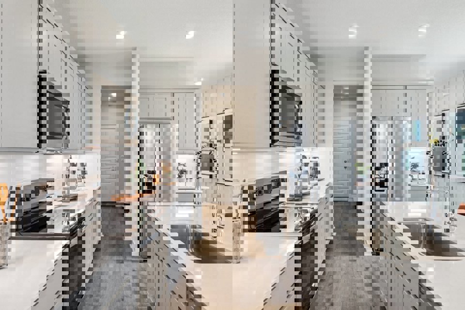 A kitchen with white cabinets.