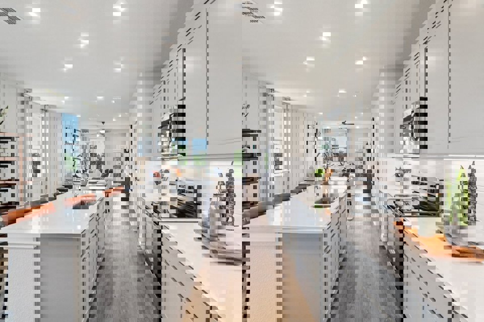 A kitchen with white cabinets.