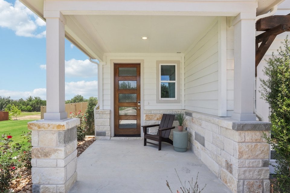A bench in front of a house.