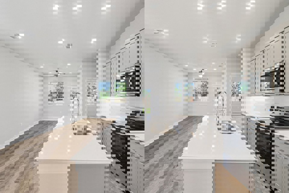 A kitchen with white cabinets.