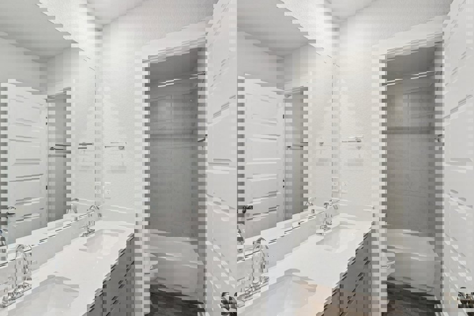 A bathroom with a sink and a shower.