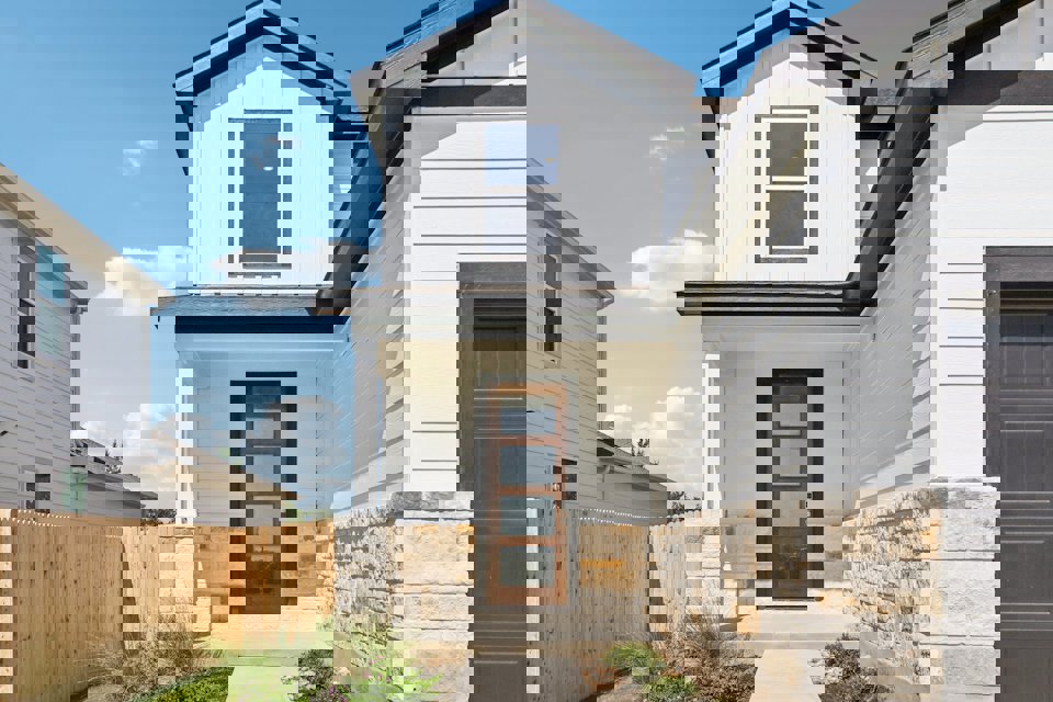 A white house with a fence.