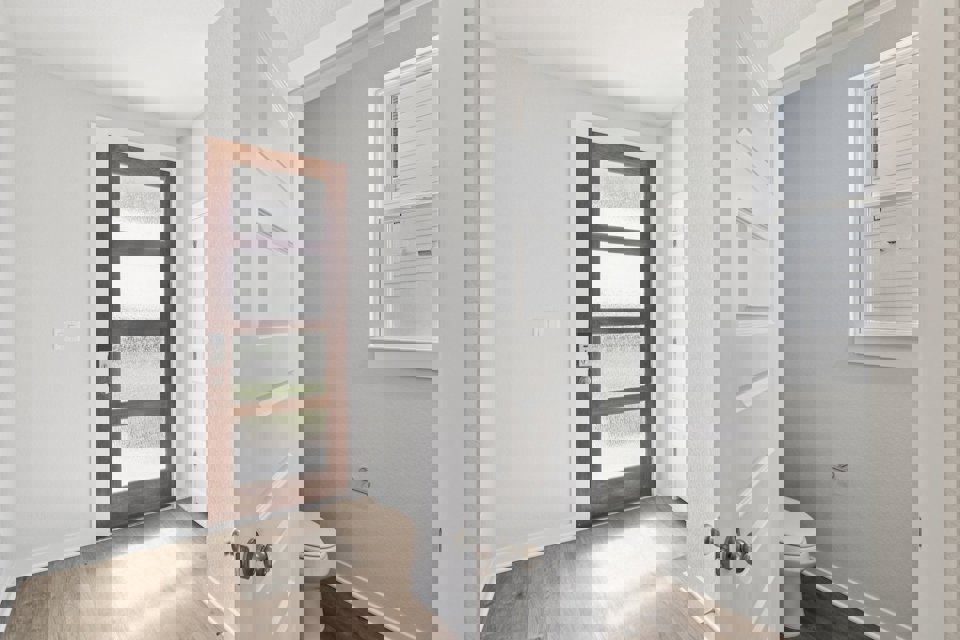 A bathroom with white walls.