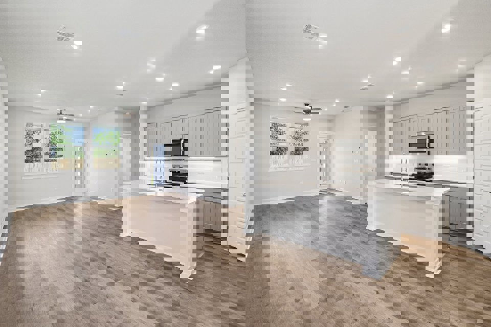 A kitchen with white cabinets.