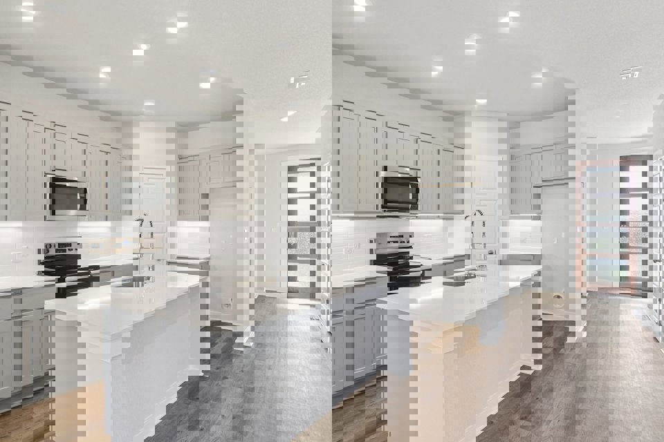 A kitchen with white cabinets.