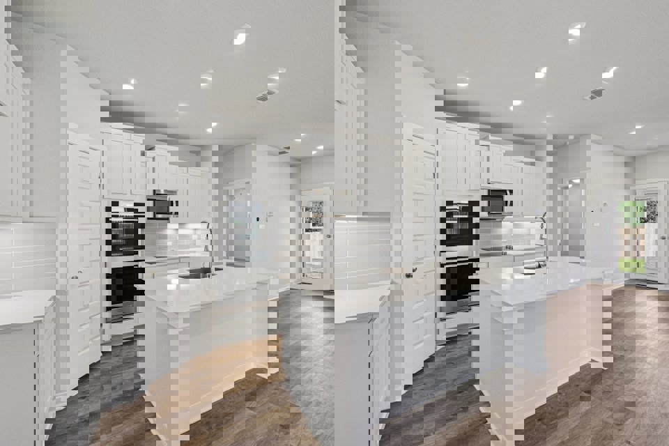 A kitchen with white cabinets.