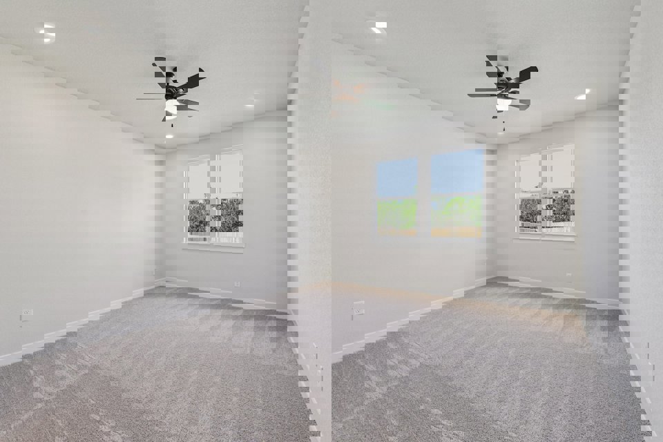 A room with a ceiling fan and a window.