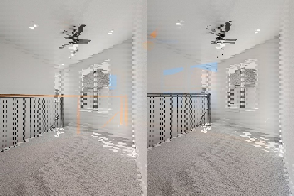 A room with a ceiling fan and a window.