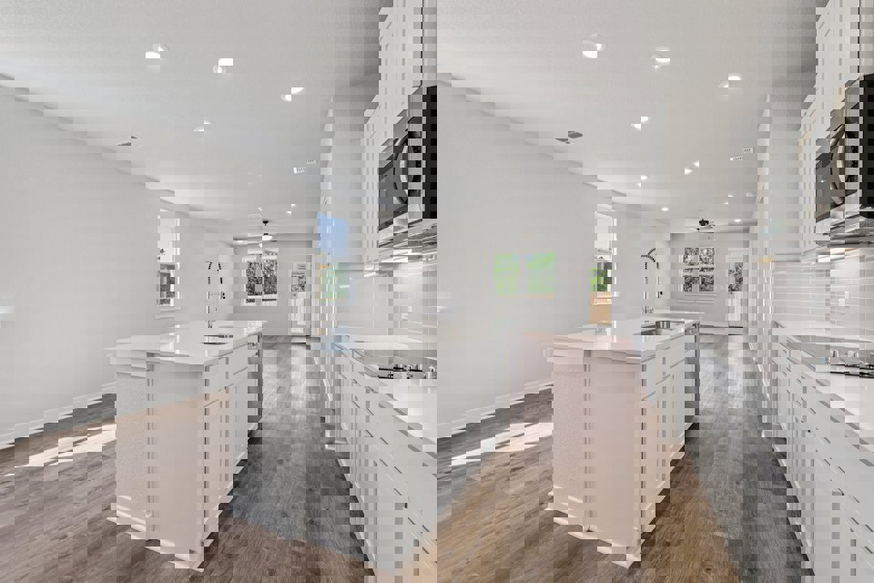 A kitchen with white cabinets.