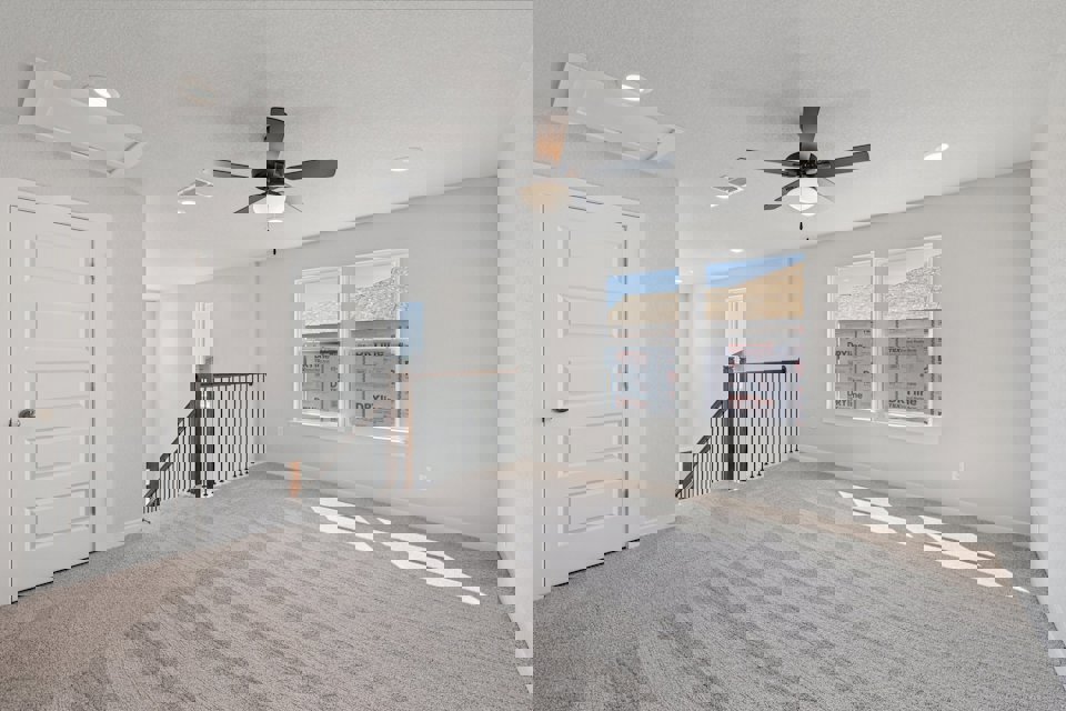 A room with a fan and a door.